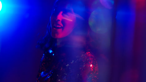 Close-Up-Of-Woman-In-Nightclub-Bar-Or-Disco-Dancing-With-Sparkling-Lights-1